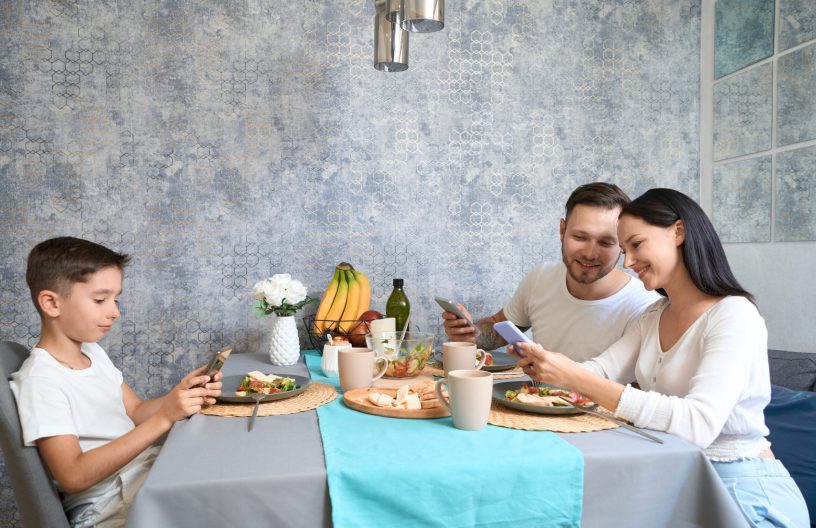 Mom, dad and son have breakfast in a familiar environment
